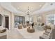 Bright living room with stylish furniture, tray ceilings, and sliding doors to outdoor patio at 12198 Sebring Ln, Venice, FL 34293