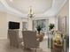 Living room with neutral decor, stylish furnishings, chandelier lighting, and sliding glass doors to an outdoor area at 12198 Sebring Ln, Venice, FL 34293