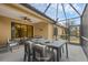 Enjoy al fresco dining on this screened patio with ceiling fan, a perfect space for relaxing and entertaining at 12198 Sebring Ln, Venice, FL 34293