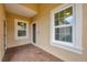 Cozy front porch with brick floor, seating, and a well-lit entry; perfect for relaxing at 12198 Sebring Ln, Venice, FL 34293