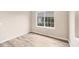 Empty room with wood floors and a window looking outside at 12198 Sebring Ln, Venice, FL 34293