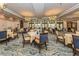 Elegant dining room with set tables, chandeliers, and large arched windows overlooking the grounds at 125 Savona, North Venice, FL 34275