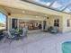 Covered patio with comfortable seating near the pool area at 125 Savona, North Venice, FL 34275