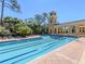 Beautiful pool with lane markers, surrounded by lush landscaping and an elegant tower at 125 Savona, North Venice, FL 34275