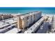 Expansive aerial view of beach condo building with stunning beachfront location and ample parking at 1255 Tarpon Center Dr # 503, Venice, FL 34285