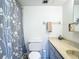 Bright and clean bathroom featuring a vanity, ample lighting, and a shower with curtain at 1255 Tarpon Center Dr # 503, Venice, FL 34285