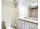 Clean bathroom with white cabinets, granite counters, and a decorative shower curtain at 1255 Tarpon Center Dr # 503, Venice, FL 34285