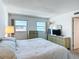 Bright bedroom with water views from multiple windows and stylish dresser set at 1255 Tarpon Center Dr # 503, Venice, FL 34285