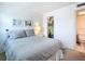 Cozy bedroom featuring a large bed and an adjacent walk-in closet and bathroom at 1255 Tarpon Center Dr # 503, Venice, FL 34285