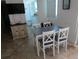 A cozy dining area featuring a table with four chairs and a flat screen tv mounted on the wall at 1255 Tarpon Center Dr # 503, Venice, FL 34285