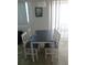 A dining area features a table with four chairs and bright window lighting at 1255 Tarpon Center Dr # 503, Venice, FL 34285