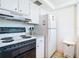 Functional kitchen featuring white appliances, cabinets, and granite countertops at 1255 Tarpon Center Dr # 503, Venice, FL 34285