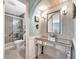 Elegant bathroom featuring a mirrored vanity table and a tiled walk-in shower for a luxurious experience at 13534 Alberta Ave, Port Charlotte, FL 33981