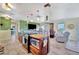 Open kitchen with a central island, tiled floors, stainless steel appliances, and a seamless connection to living spaces at 13534 Alberta Ave, Port Charlotte, FL 33981