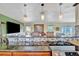 Spacious kitchen with an island cooktop, decorative backsplash, and an open layout to the living area at 13534 Alberta Ave, Port Charlotte, FL 33981