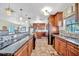 Well-appointed kitchen features wooden cabinets, a large island, and a seamless transition to the living space at 13534 Alberta Ave, Port Charlotte, FL 33981