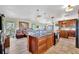 Open-concept kitchen boasts wooden cabinets, granite countertops, and a seamless flow into the living area at 13534 Alberta Ave, Port Charlotte, FL 33981