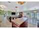 Open-concept living space featuring a kitchen with wooden island, dining area, and living room with leather furniture at 13534 Alberta Ave, Port Charlotte, FL 33981