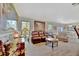 Bright living room featuring stylish furniture, luxury flooring, and natural light from large windows at 13534 Alberta Ave, Port Charlotte, FL 33981