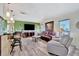 Spacious living room features luxury vinyl flooring, modern lighting, and stylish furniture at 13534 Alberta Ave, Port Charlotte, FL 33981