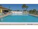 Beautiful community pool with clear blue water and inviting lounge area at 13534 Alberta Ave, Port Charlotte, FL 33981