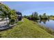 A side yard view showcases the screened lanai with a private waterfront at 142 Braemar Ave, Venice, FL 34293