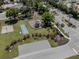 Community park featuring a playground, basketball court, shuffleboard, and green space for recreation at 142 Braemar Ave, Venice, FL 34293