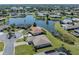 Expansive aerial view of the property, showcasing its prime location in a waterfront community at 1602 Jim Jim Ct, Venice, FL 34293