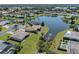 An aerial view of the neighborhood, showcasing the home's proximity to a serene lake and lush landscaping at 1602 Jim Jim Ct, Venice, FL 34293