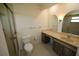 Bathroom features a vanity with storage, toilet, and glass enclosed shower at 1602 Jim Jim Ct, Venice, FL 34293