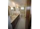 Bathroom features a dual sink vanity and tiled shower and tub at 1602 Jim Jim Ct, Venice, FL 34293