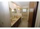 Bathroom features a dual sink vanity and tiled shower and tub at 1602 Jim Jim Ct, Venice, FL 34293