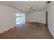 Large bedroom with carpet, sliding glass door, and neutral wall paint at 1602 Jim Jim Ct, Venice, FL 34293