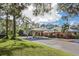 A well-maintained clubhouse features lush landscaping and dedicated parking at 1602 Jim Jim Ct, Venice, FL 34293