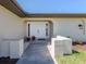 An eye-level view of a welcoming front entrance with double doors and decorative flower boxes at 1602 Jim Jim Ct, Venice, FL 34293