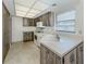 Kitchen with rustic style cabinets, white appliances, and tiled floor at 1602 Jim Jim Ct, Venice, FL 34293