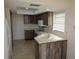 Clean kitchen with wooden cabinets, white countertops and appliances at 1602 Jim Jim Ct, Venice, FL 34293