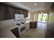 Cozy kitchen with rustic wooden cabinets and modern white appliances at 1602 Jim Jim Ct, Venice, FL 34293