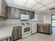 Functional kitchen with wood cabinets, white appliances, and ample counter space at 1602 Jim Jim Ct, Venice, FL 34293