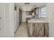 An interior view of a galley kitchen showcasing rustic cabinets, ample storage and natural light at 1602 Jim Jim Ct, Venice, FL 34293