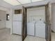 Convenient laundry area with washer, dryer, and a fridge; perfect for modern living at 1602 Jim Jim Ct, Venice, FL 34293