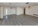 A spacious living room with modern grey flooring, a double door entry, and contemporary light fixtures at 1602 Jim Jim Ct, Venice, FL 34293