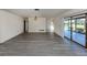 Spacious living room boasts new flooring and sliding glass doors to a screened lanai at 1602 Jim Jim Ct, Venice, FL 34293