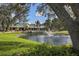 Beautiful view of the clubhouse overlooking a tranquil pond with fountain at 1602 Jim Jim Ct, Venice, FL 34293