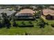 Aerial view of a lovely home with a screened-in pool, lush backyard, and well-kept landscaping at 1662 Bobcat Trl, North Port, FL 34288