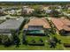 Aerial view of a well-maintained home with a screened-in pool, lush backyard, and mature landscaping at 1662 Bobcat Trl, North Port, FL 34288