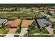 An aerial view of the homes featuring beautiful tile roofs with a pond and nature preserve in the background at 1662 Bobcat Trl, North Port, FL 34288