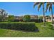 Beautiful backyard with lush landscaping and a screened-in lanai, perfect for outdoor enjoyment at 1662 Bobcat Trl, North Port, FL 34288