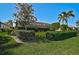 Well-maintained backyard featuring a manicured lawn, mature trees, hedges and screened in lanai at 1662 Bobcat Trl, North Port, FL 34288