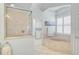Bright bathroom featuring a glass shower, a soaking tub with plantation shutters and decor at 1662 Bobcat Trl, North Port, FL 34288
